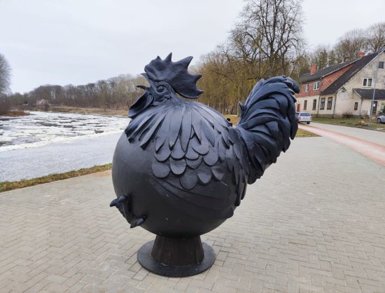 Art object Black rooster in a ball