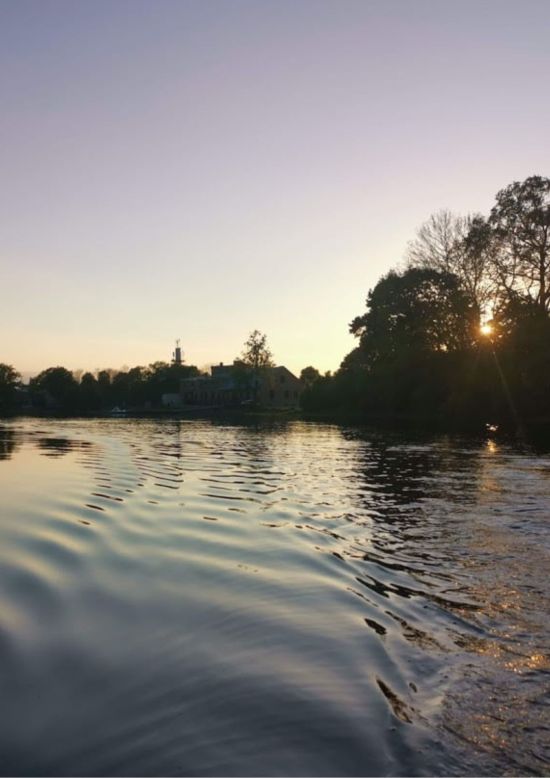 Sunrise on a SUP board at the Rundāle Watermill Lake